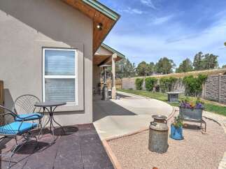 Enjoy outdoor living on this charming patio featuring comfortable seating and a dining area perfect for al fresco meals.