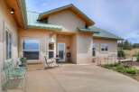 This charming home features a welcoming stucco exterior with a durable metal roof, perfect for any climate.