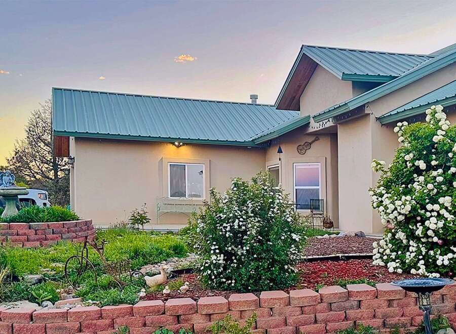 Charming home with a beautiful blooming garden and a welcoming facade.