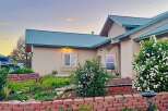 Charming home with a beautiful blooming garden and a welcoming facade.
