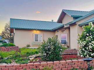 Charming home with a beautiful blooming garden and a welcoming facade.