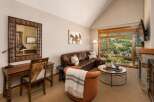 Experience luxury living with this stunning living room featuring a plush leather sectional sofa and a cozy accent chair, perfect for relaxing.