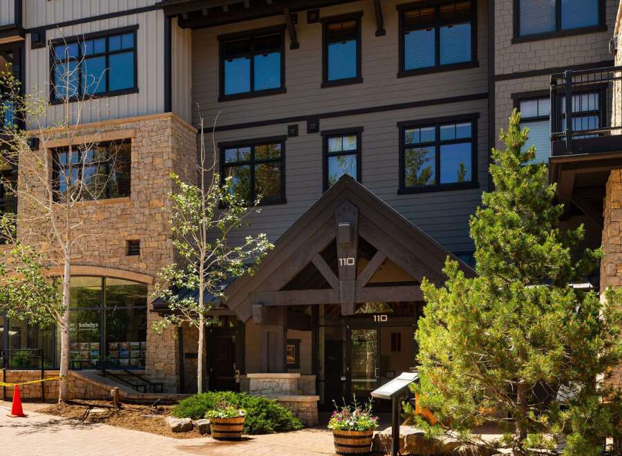 Discover luxury living in this stunning property featuring a modern exterior with stone and siding accents.