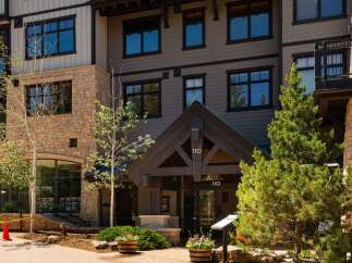 Discover luxury living in this stunning property featuring a modern exterior with stone and siding accents.