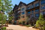 Discover luxury living in this stunning multi-story building featuring a blend of modern and rustic architecture.