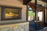 Discover the charm of Capitol Peak A, a property featuring a striking entrance with a decorative sign showcasing a mountain landscape.