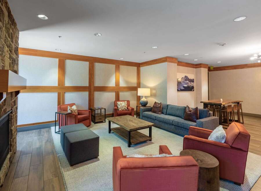 Experience comfort and style in this inviting living space, featuring a cozy stone fireplace and ample seating.