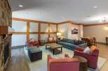 Experience comfort and style in this inviting living space, featuring a cozy stone fireplace and ample seating.