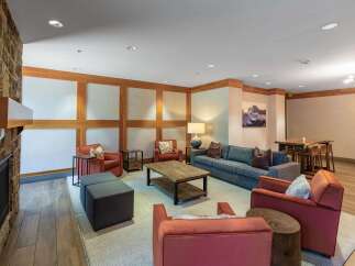 Experience comfort and style in this inviting living space, featuring a cozy stone fireplace and ample seating.
