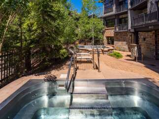 Experience ultimate relaxation in this stunning outdoor oasis, featuring a luxurious stainless steel hot tub perfect for unwinding.