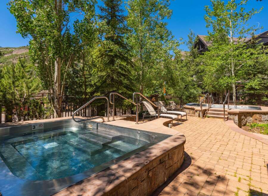 Indulge in ultimate relaxation with this luxurious outdoor spa area, featuring a spacious hot tub perfect for unwinding.