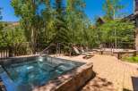 Indulge in ultimate relaxation with this luxurious outdoor spa area, featuring a spacious hot tub perfect for unwinding.