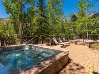 Indulge in ultimate relaxation with this luxurious outdoor spa area, featuring a spacious hot tub perfect for unwinding.