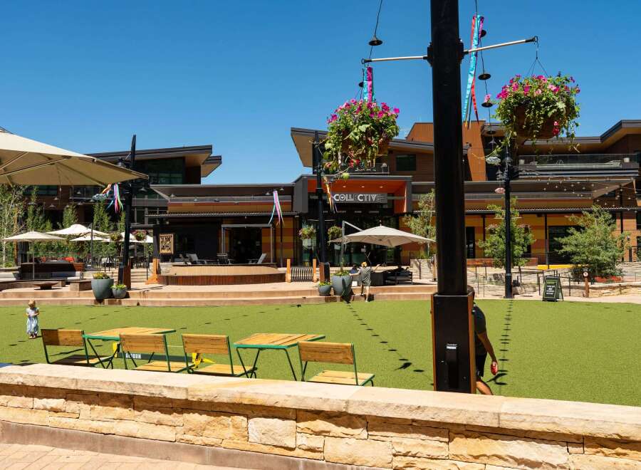 Experience vibrant outdoor living in this modern commercial space, featuring a spacious artificial turf lawn perfect for events and gatherings.