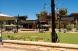 Experience vibrant outdoor living in this modern commercial space, featuring a spacious artificial turf lawn perfect for events and gatherings.