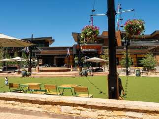 Experience vibrant outdoor living in this modern commercial space, featuring a spacious artificial turf lawn perfect for events and gatherings.