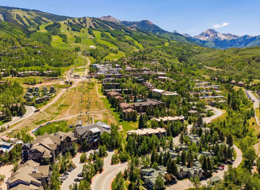 Experience luxury mountain living in this stunning aerial view of a ski resort community.