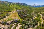 Experience luxury mountain living in this stunning aerial view of a ski resort community.