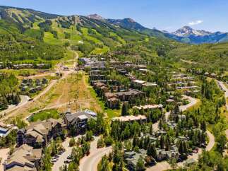 Experience luxury mountain living in this stunning aerial view of a ski resort community.