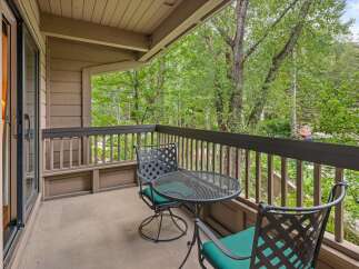 Enjoy your morning coffee or evening relaxation on this charming balcony, complete with a wrought-iron table and chairs.