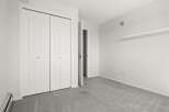 This spacious room features a large white bi-fold closet, perfect for ample storage.