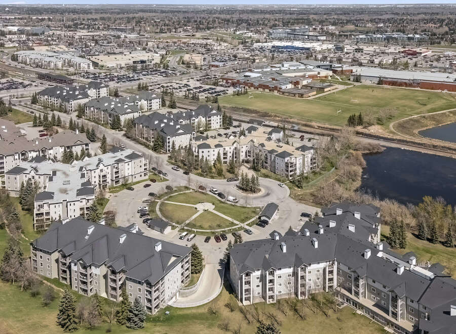Discover modern living in this expansive apartment complex, featuring a central courtyard and ample parking.