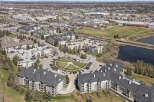 Discover modern living in this expansive apartment complex, featuring a central courtyard and ample parking.