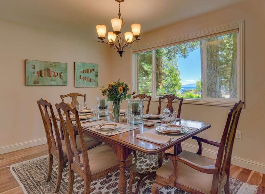 Enjoy breathtaking lake views from this elegant dining room, perfect for hosting memorable gatherings.