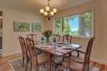 Enjoy breathtaking lake views from this elegant dining room, perfect for hosting memorable gatherings.
