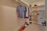 Discover organized living in this spacious walk-in closet, featuring ample hanging space for your wardrobe and well-organized shelving for accessories.