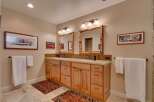 This spacious bathroom features a double vanity with ample storage and granite countertops, perfect for any household.