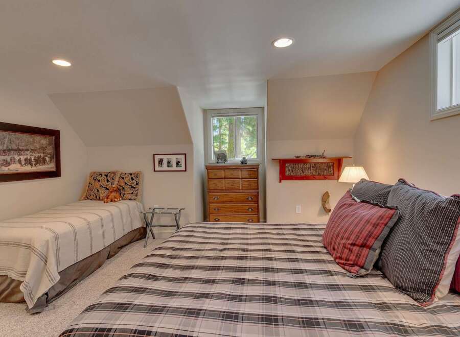 This charming bedroom features two beds, perfect for accommodating family or guests.