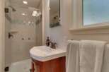 This charming bathroom features a modern glass-enclosed shower with elegant tile work and bronze fixtures.