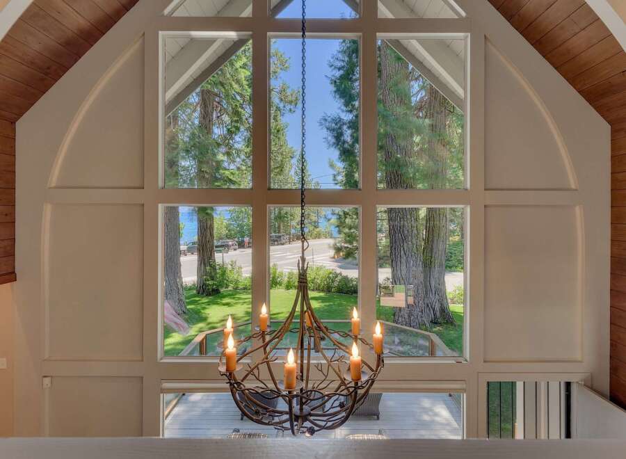 Experience breathtaking lake views through a stunning wall of windows in this unique property.