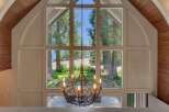 Experience breathtaking lake views through a stunning wall of windows in this unique property.