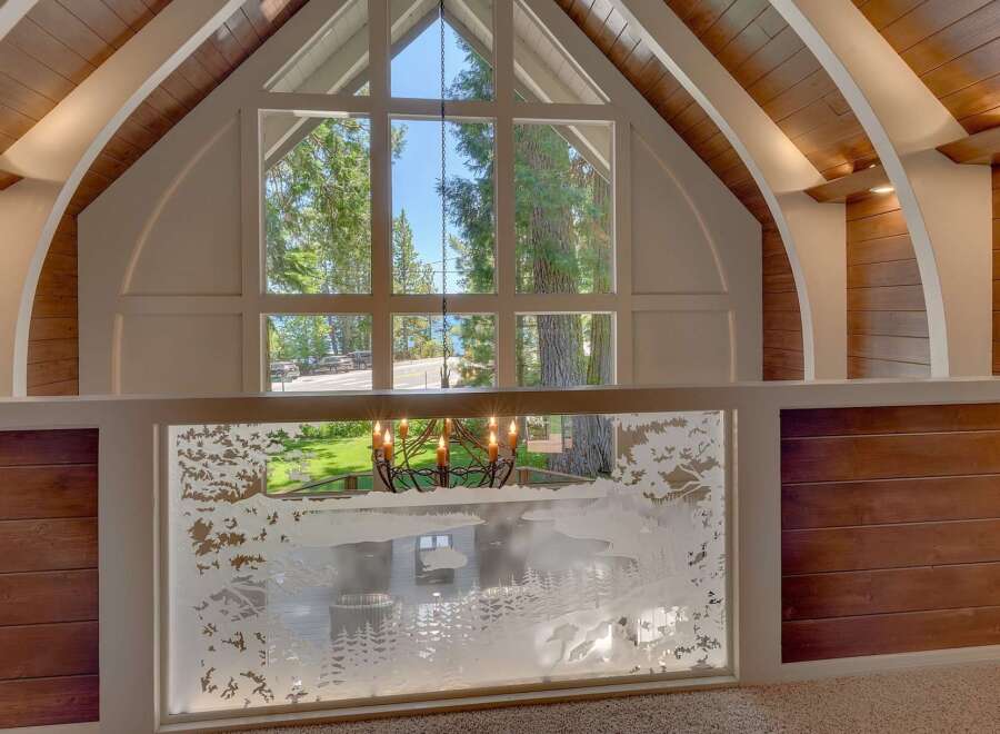 Experience breathtaking lake views through a stunning, expansive window that floods the living space with natural light.