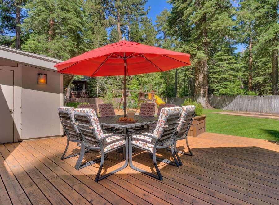 Enjoy outdoor dining and relaxation on this spacious wooden deck, perfect for entertaining.