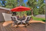 Enjoy outdoor dining and relaxation on this spacious wooden deck, perfect for entertaining.