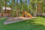 Enjoy endless family fun in this spacious backyard, complete with a vibrant playground featuring swings, a climbing wall, and a thrilling yellow slide.