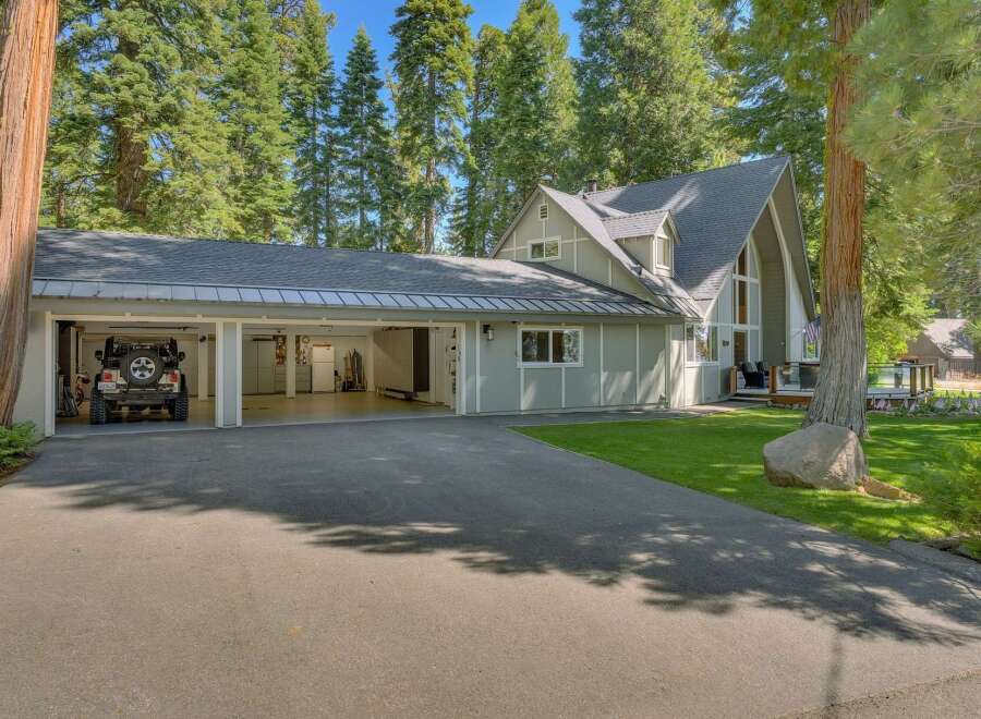 Discover this stunning property featuring a spacious multi-car garage with ample storage, perfect for vehicles and outdoor gear.