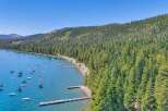 Experience the ultimate lakeside lifestyle with this stunning aerial view of a serene bay dotted with numerous boats.