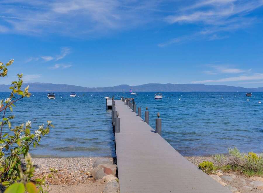 Enjoy breathtaking lake views from this stunning property featuring a private dock perfect for your boat.
