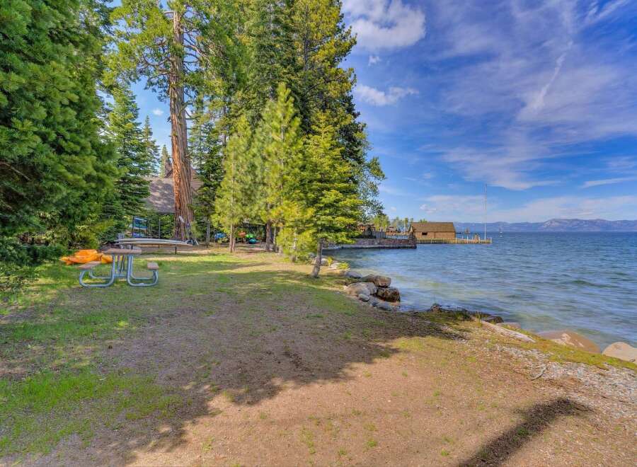 Enjoy serene lakefront living with this stunning property, featuring a private dock and boathouse perfect for water enthusiasts.