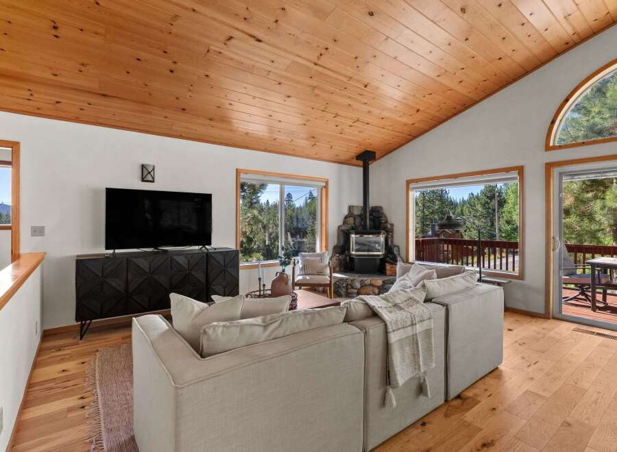 Experience cozy living in this mountain retreat, featuring a stunning stone fireplace as the centerpiece of the living room.