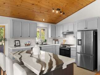 Experience modern living in this stunning kitchen, featuring sleek grey cabinetry and a striking quartz island with a unique, flowing pattern.