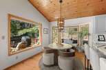 Enjoy breathtaking views from this dining area, featuring a round table and comfortable seating perfect for intimate meals.