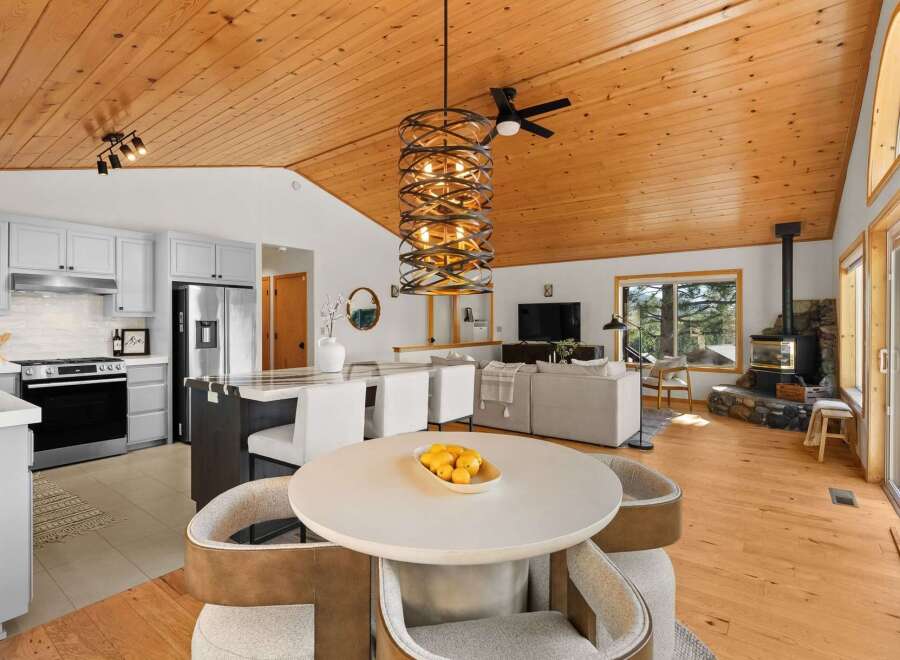 Experience modern living in this open-concept home featuring a gourmet kitchen with stainless steel appliances and a spacious island, perfect for entertaining.