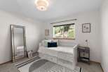 This charming bedroom features a comfortable white daybed with ample storage drawers, perfect for maximizing space.