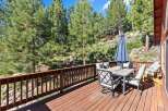 Enjoy outdoor living on this spacious wooden deck, perfect for entertaining or relaxing amidst a serene natural setting.