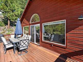 Enjoy outdoor living on this spacious wooden deck, perfect for entertaining or relaxing.